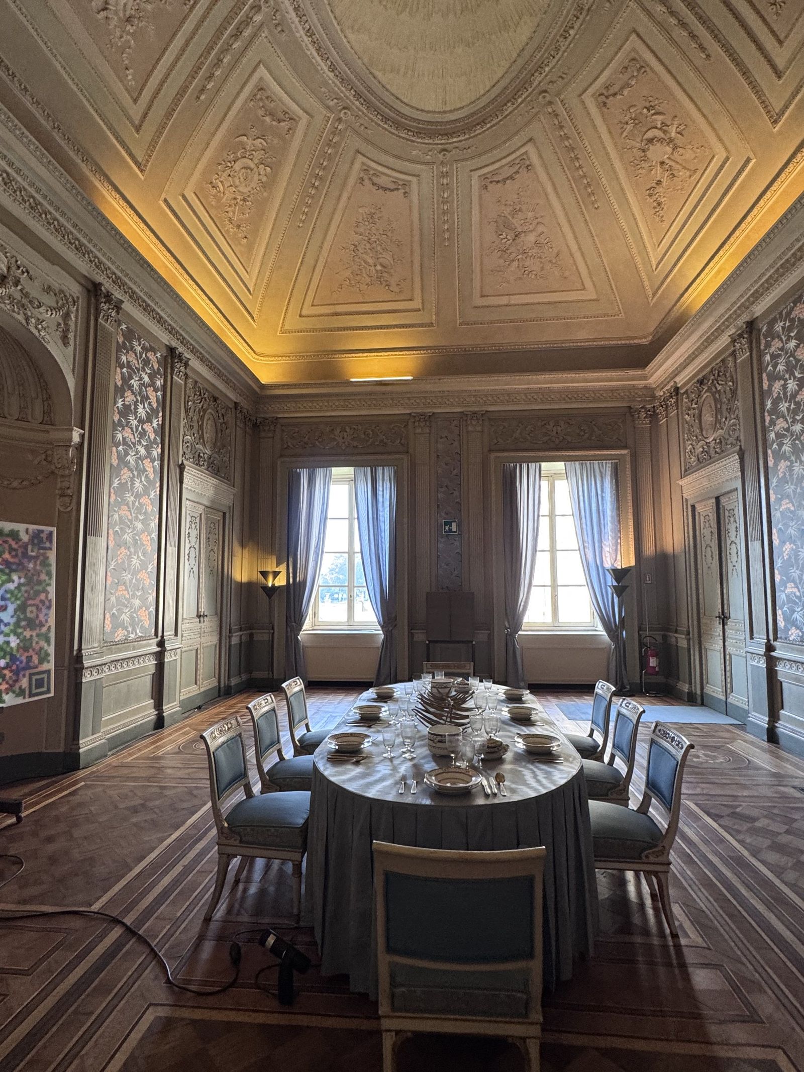 The blue dining room of the Villa Reale, Monza, laid for dinner